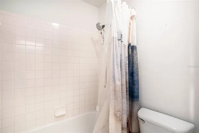 a bathroom with a shower and a toilet