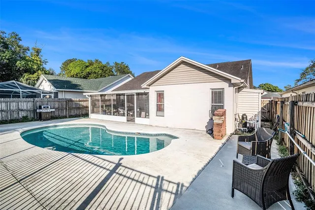 a view of a house with swimming pool and sitting area