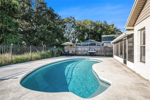 a view of a swimming pool with a patio