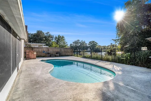 a view of a swimming pool with a yard