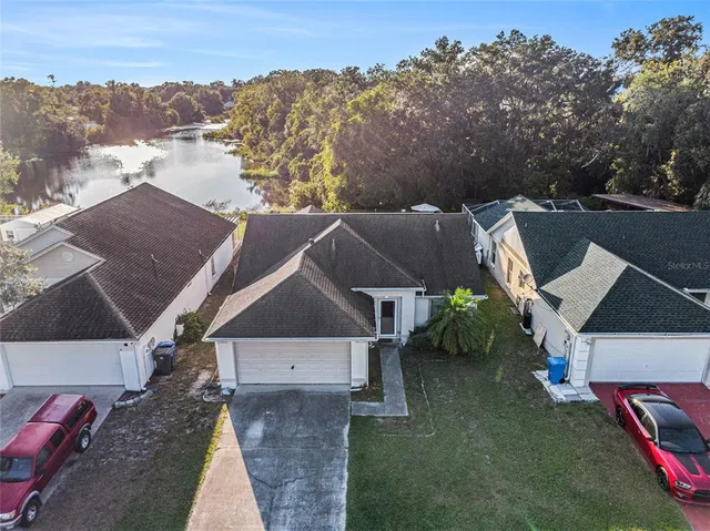an aerial view of a house with a yard