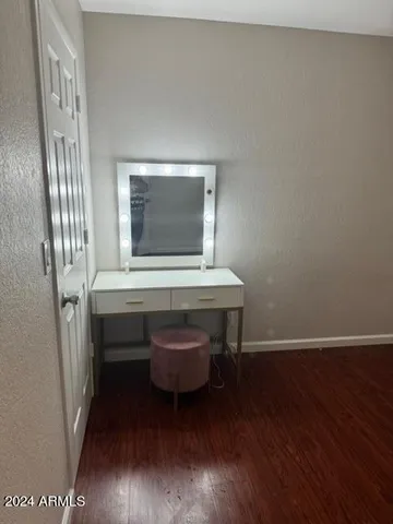 a room with wooden floor and furniture