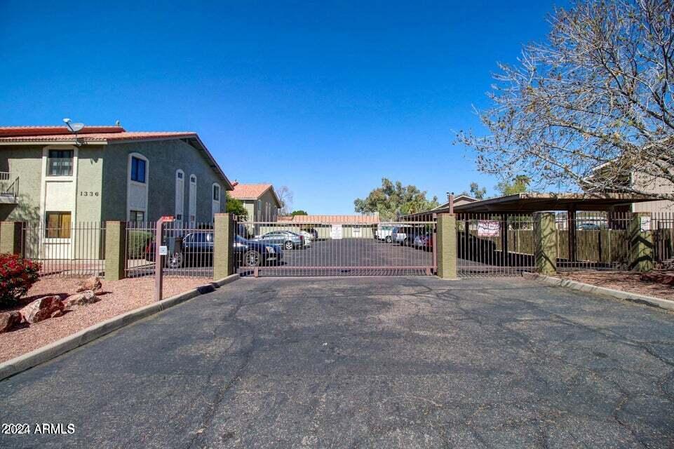 1336 East Mountain View Road, Unit 202 Phoenix, AZ 85020 - Photo 2 of 23 a view of a house with a yard and garage