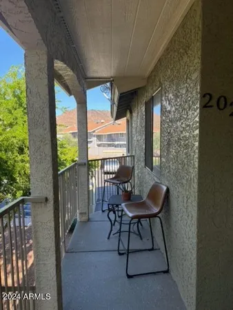 a balcony with furniture and a potted plant