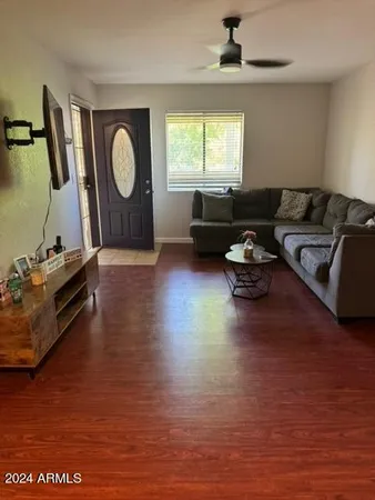 a living room with furniture window and a wooden floor