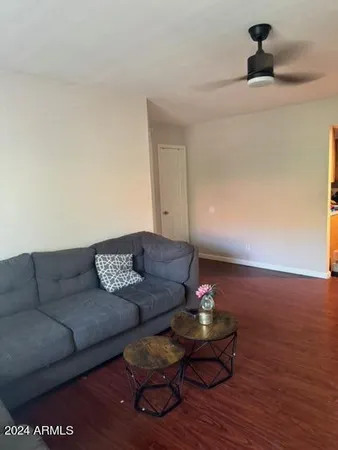 a living room with furniture and a wooden floor