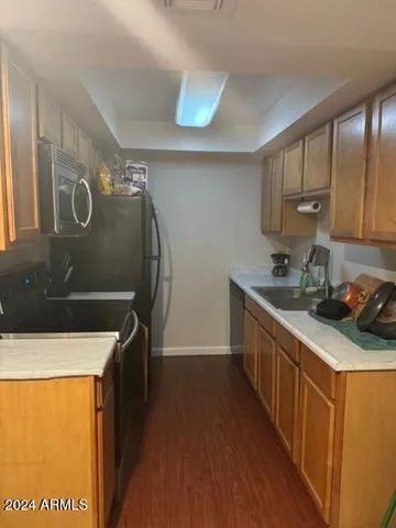 a kitchen with stainless steel appliances a stove a sink and a refrigerator