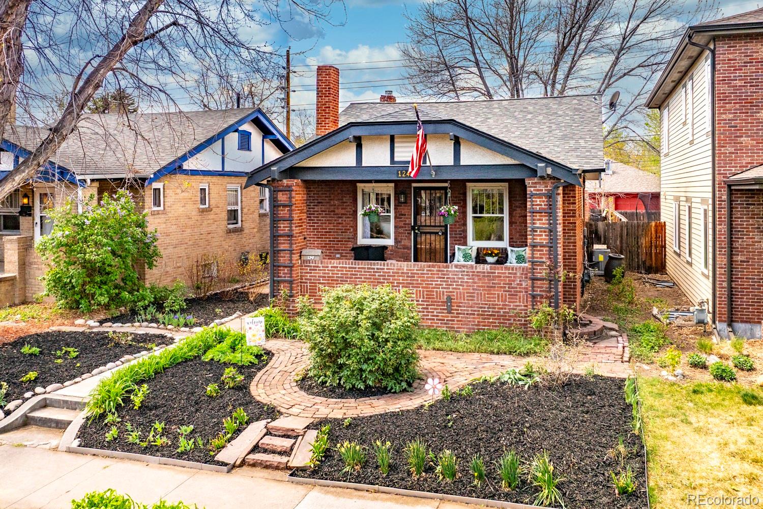 1247 Harrison Street Denver, CO 80206 - Photo 1 of 50 a front view of a house with garden
