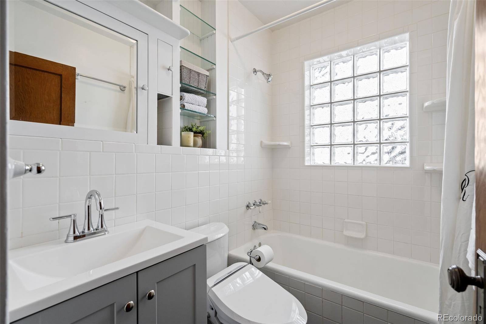 1247 Harrison Street Denver, CO 80206 - Photo 19 of 50 a bathroom with a sink toilet and shower