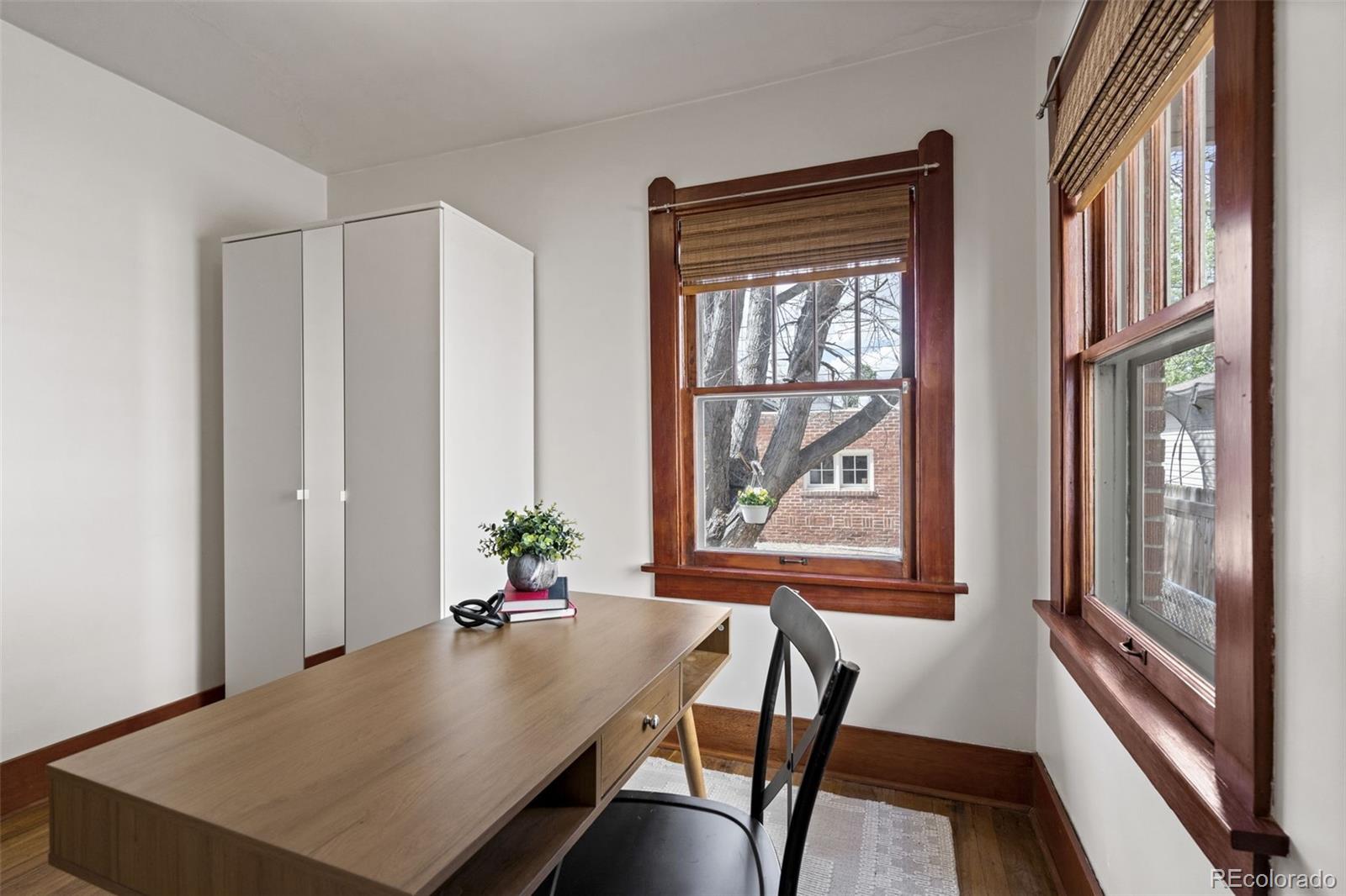 1247 Harrison Street Denver, CO 80206 - Photo 21 of 50 a view of a room with furniture large windows and wooden floor