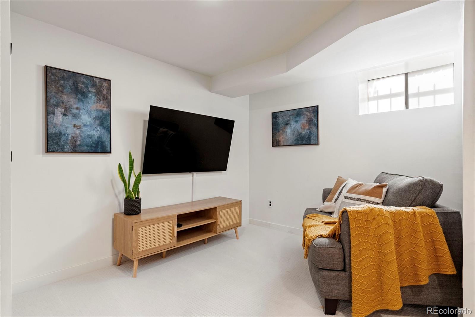 1247 Harrison Street Denver, CO 80206 - Photo 26 of 50 a living room with furniture and a flat screen tv