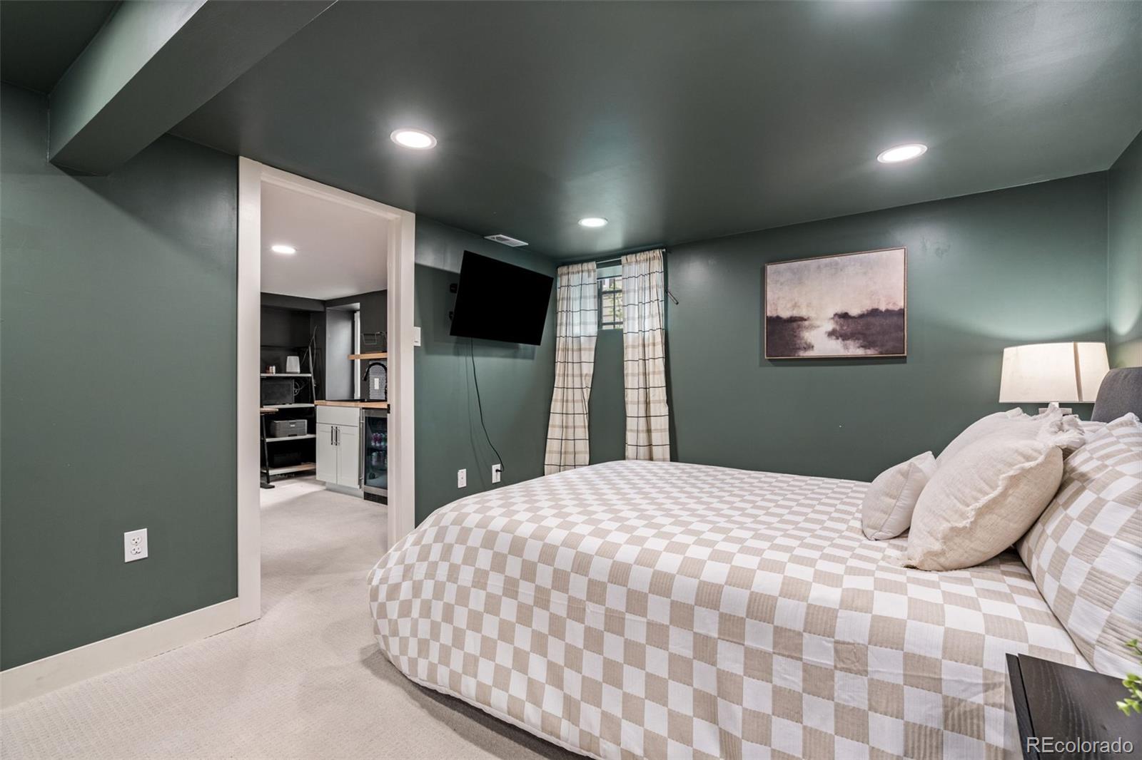 1247 Harrison Street Denver, CO 80206 - Photo 31 of 50 a bedroom with a bed and a television
