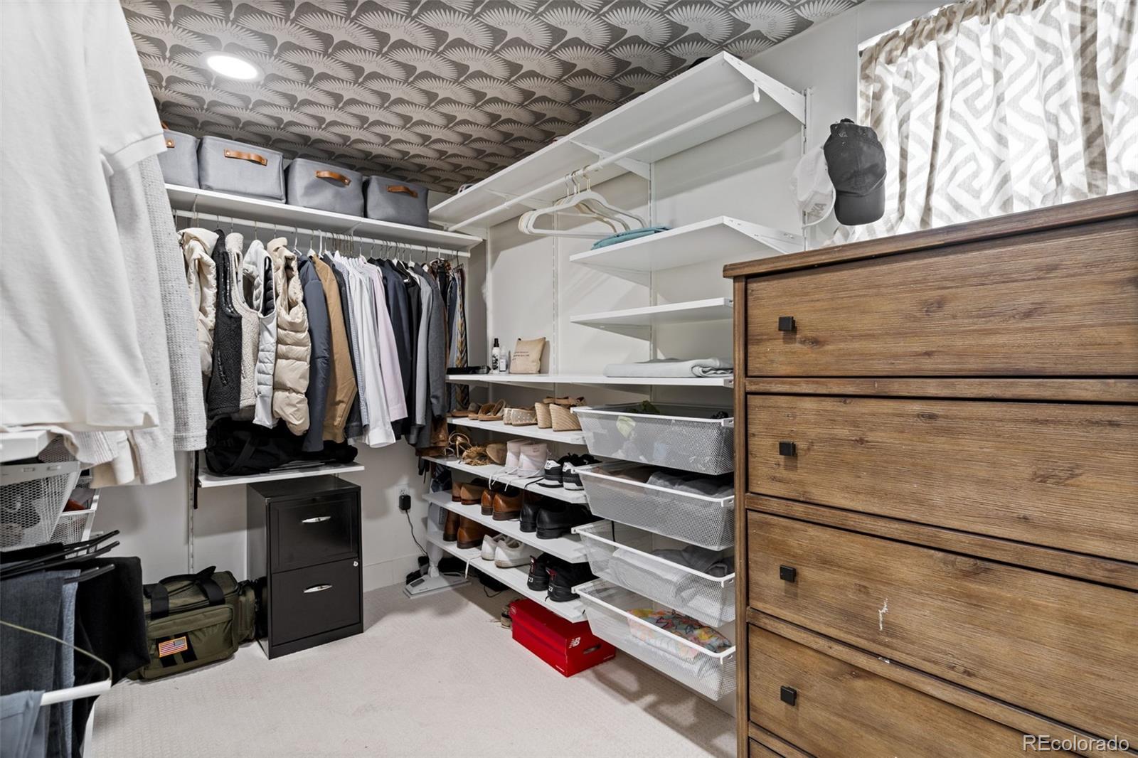 1247 Harrison Street Denver, CO 80206 - Photo 32 of 50 a view of walk in closet with clothes and shoes