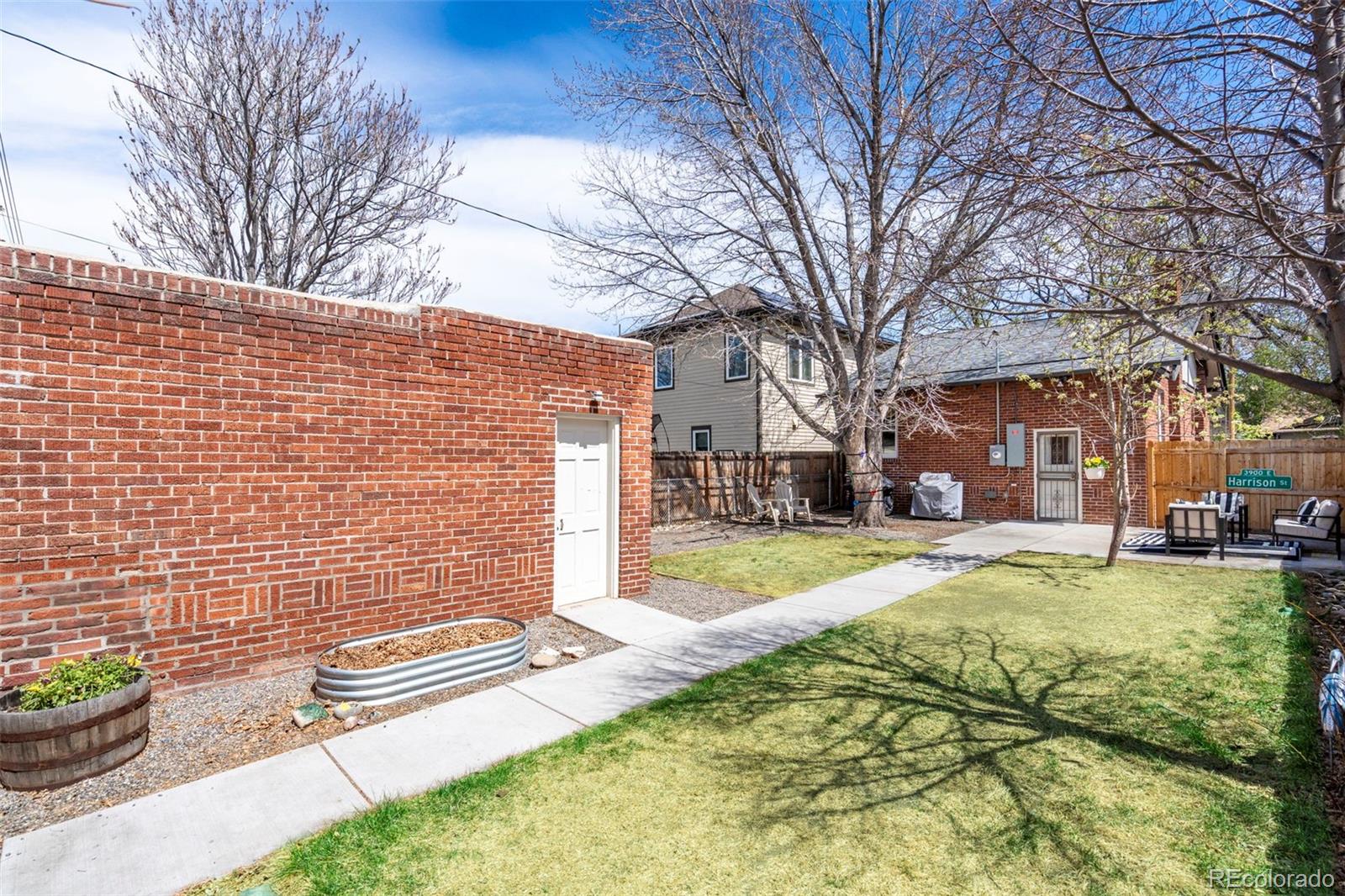 1247 Harrison Street Denver, CO 80206 - Photo 37 of 50 a view of a house with a yard and sitting area