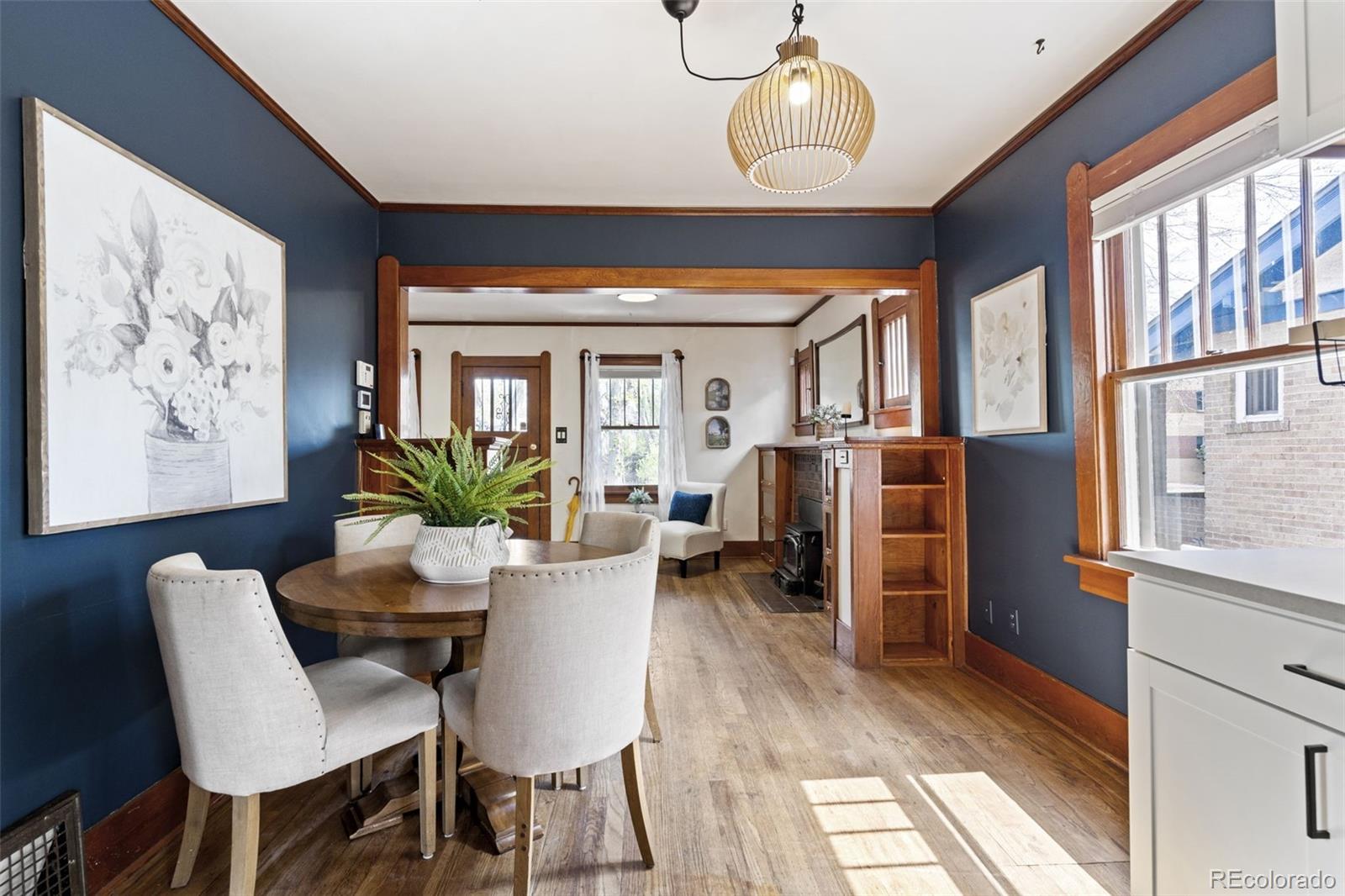 1247 Harrison Street Denver, CO 80206 - Photo 10 of 50 a view of a dining room with furniture window and wooden floor
