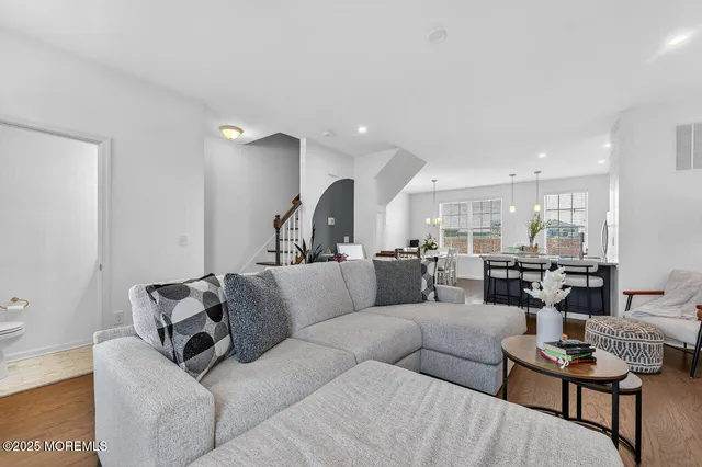 a living room with furniture kitchen view and a table