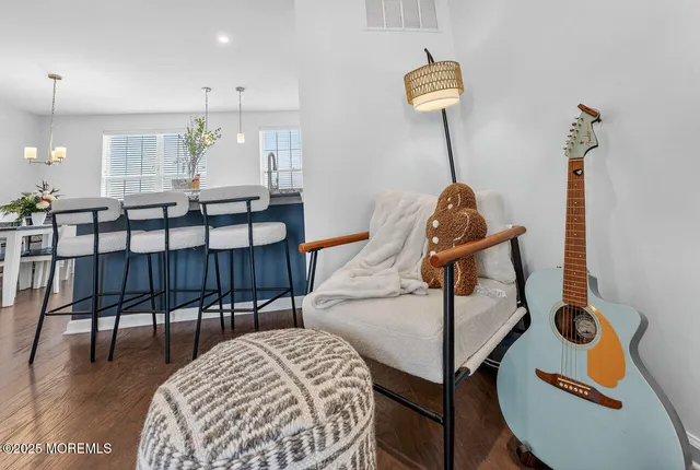 a living room with furniture a rug and white walls