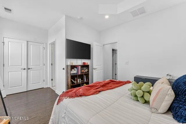 a bedroom with a bed and a television