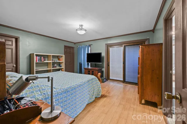 a bedroom with a large bed and a chandelier