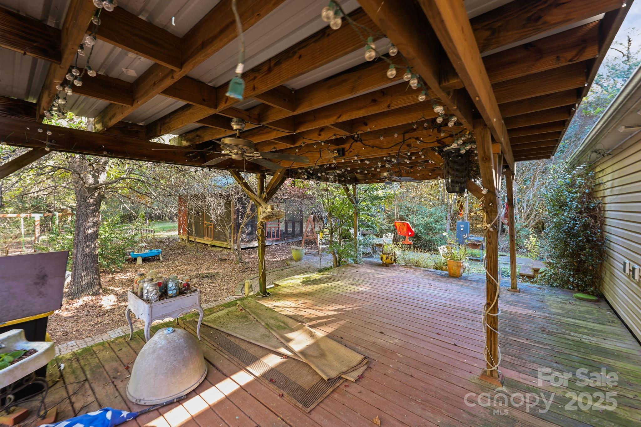 952 Flat Swamp Road Denton, NC 27239 - Photo 33 of 37 a view of a porch with furniture and a backyard