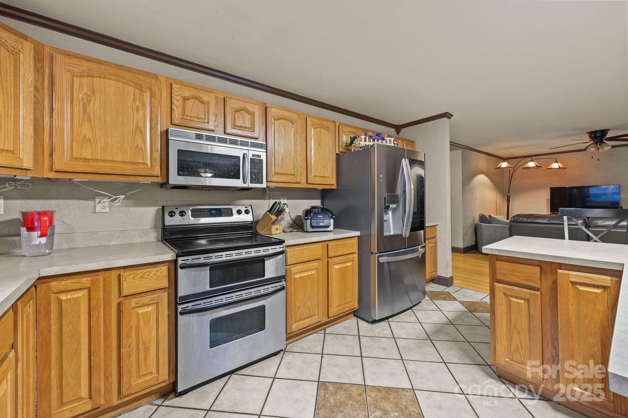 952 Flat Swamp Road Denton, NC 27239 - Photo 8 of 37 a kitchen with a sink cabinets and stainless steel appliances