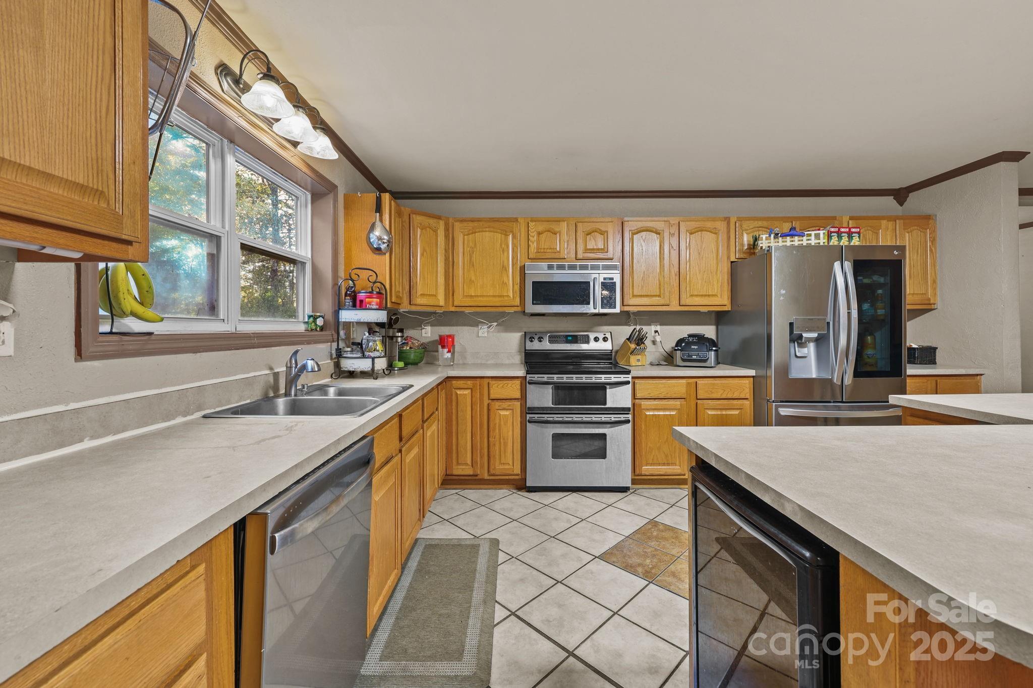 952 Flat Swamp Road Denton, NC 27239 - Photo 10 of 37 a kitchen with granite countertop a sink a counter top space appliances and cabinets