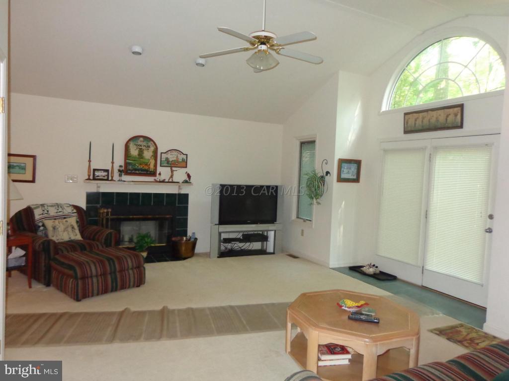 183 Windjammer Road Berlin, MD 21811 - Photo 2 of 18 a living room with furniture and a fireplace
