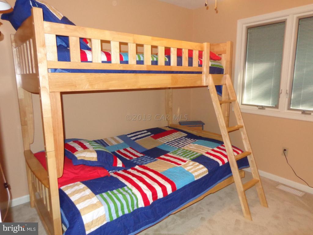 183 Windjammer Road Berlin, MD 21811 - Photo 11 of 18 a bedroom with a bed and a window