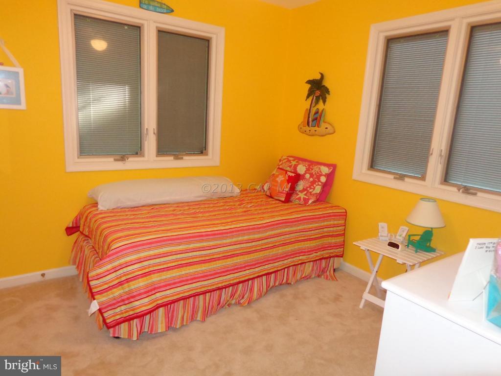 183 Windjammer Road Berlin, MD 21811 - Photo 12 of 18 a bedroom with a bed and cabinets