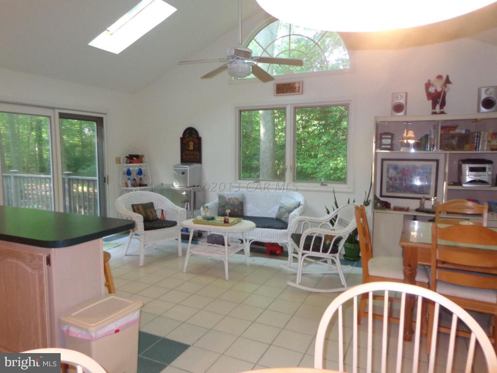 183 Windjammer Road Berlin, MD 21811 - Photo 6 of 18 a living room with fireplace furniture and a chandelier