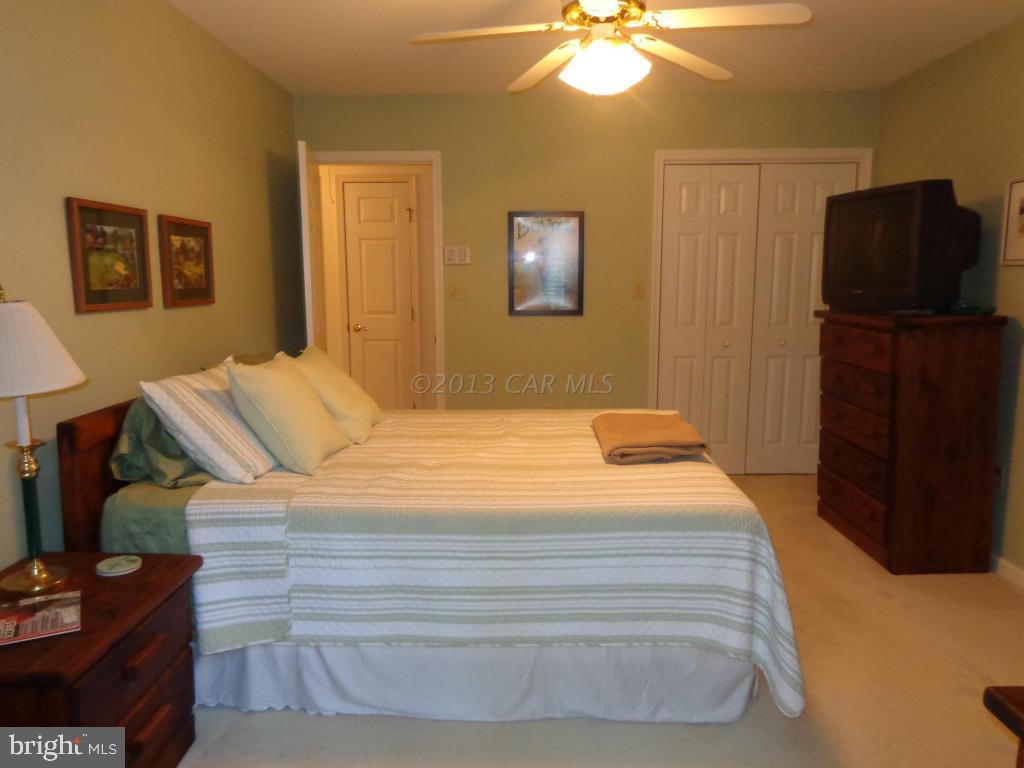 183 Windjammer Road Berlin, MD 21811 - Photo 9 of 18 a bedroom with a bed and wooden floor