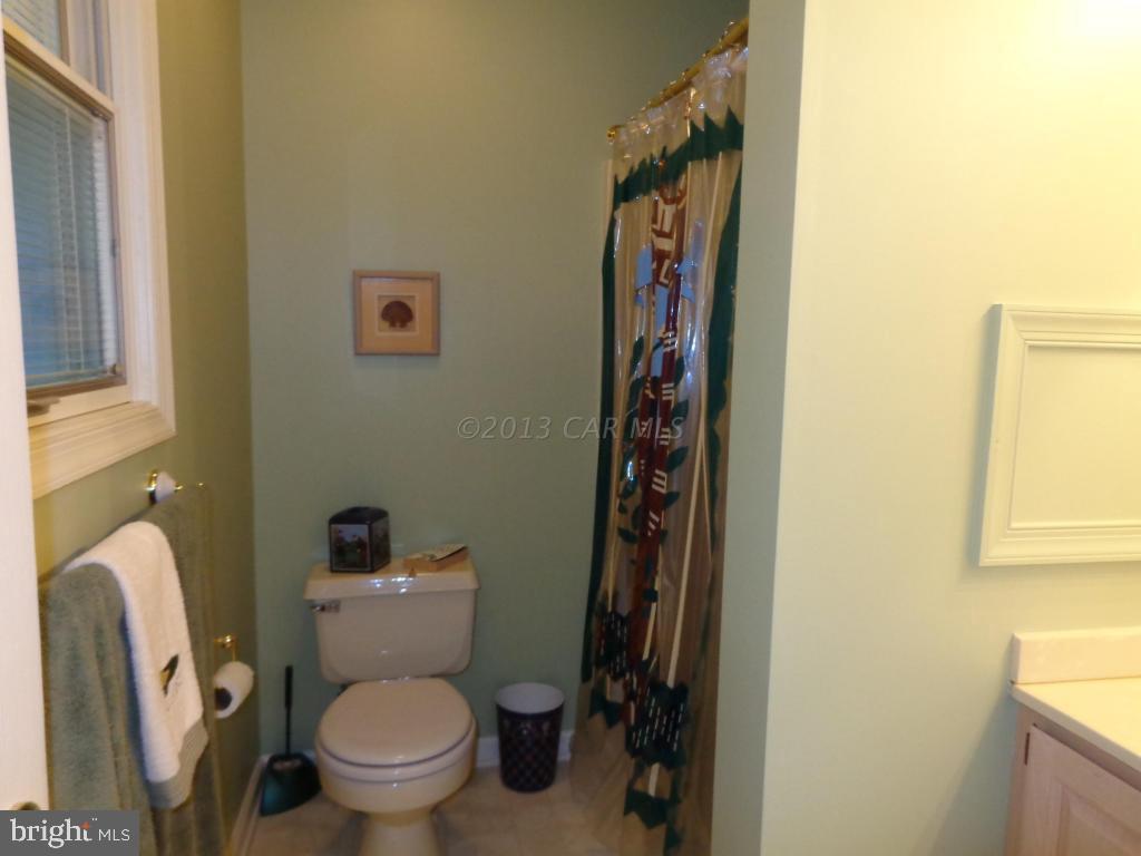 183 Windjammer Road Berlin, MD 21811 - Photo 10 of 18 a white toilet sitting next to a small sink