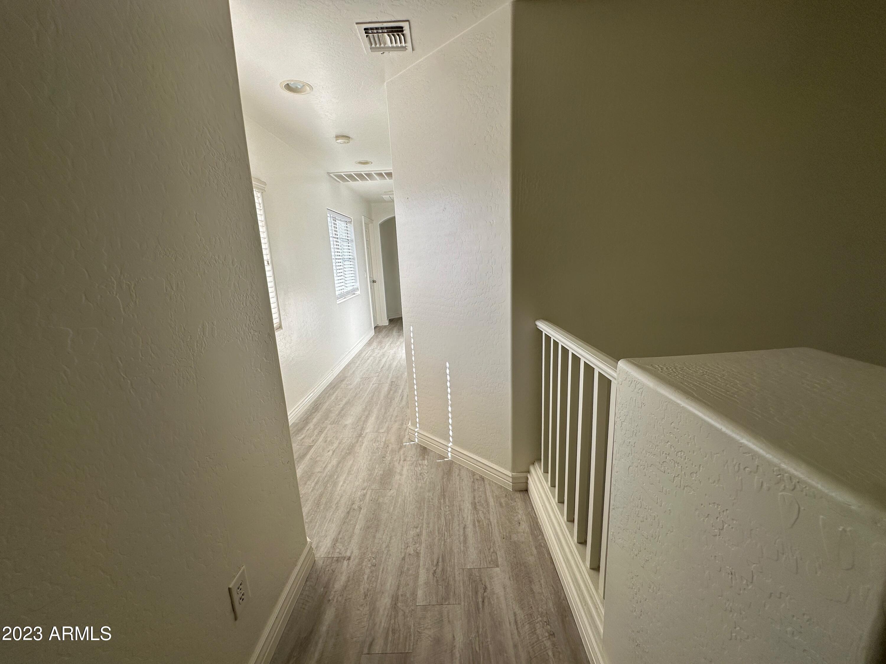 4734 East Olney Avenue Gilbert, AZ 85234 - Photo 17 of 26 a view of a hallway with wooden floor and staircase