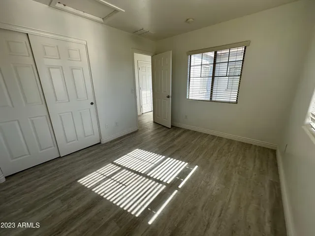 a view of wooden floor and windows in a room