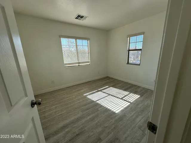a view of wooden floor and windows in a room
