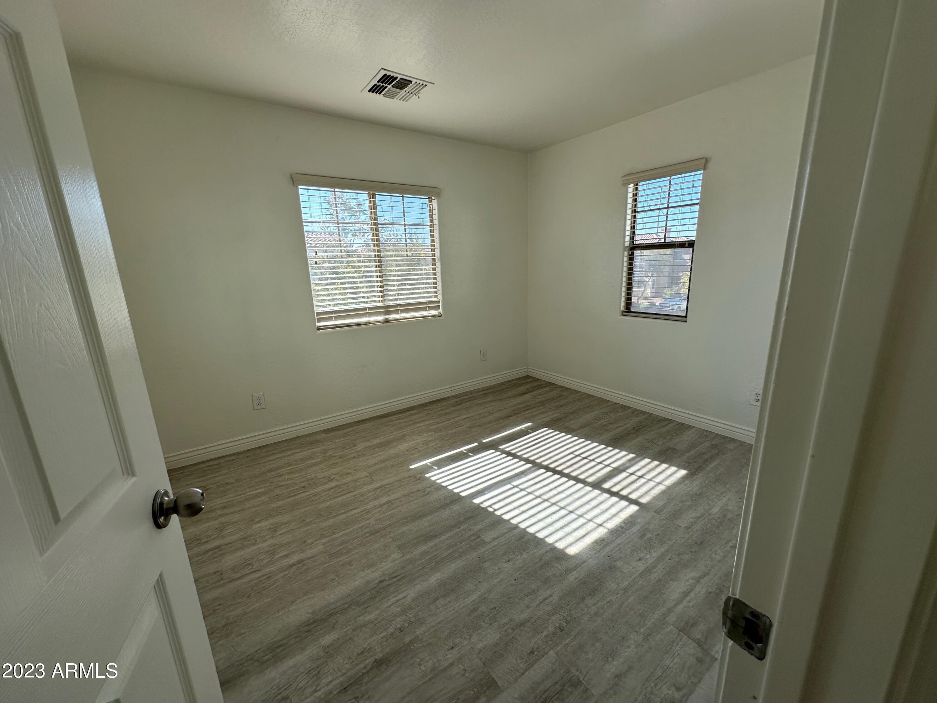4734 East Olney Avenue Gilbert, AZ 85234 - Photo 20 of 26 a view of wooden floor and windows in a room