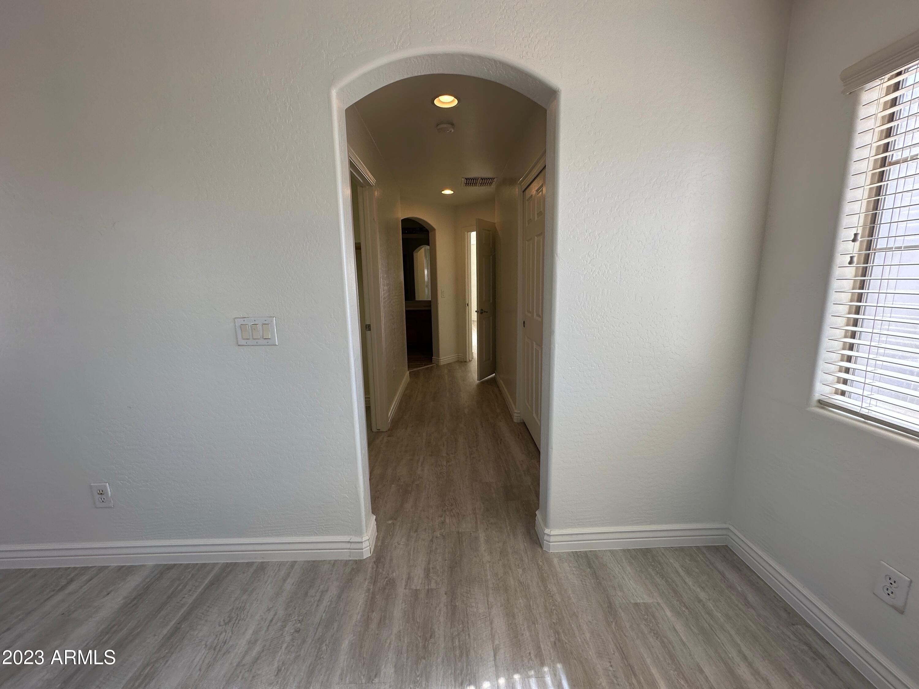 4734 East Olney Avenue Gilbert, AZ 85234 - Photo 23 of 26 wooden floor in a hall with a window