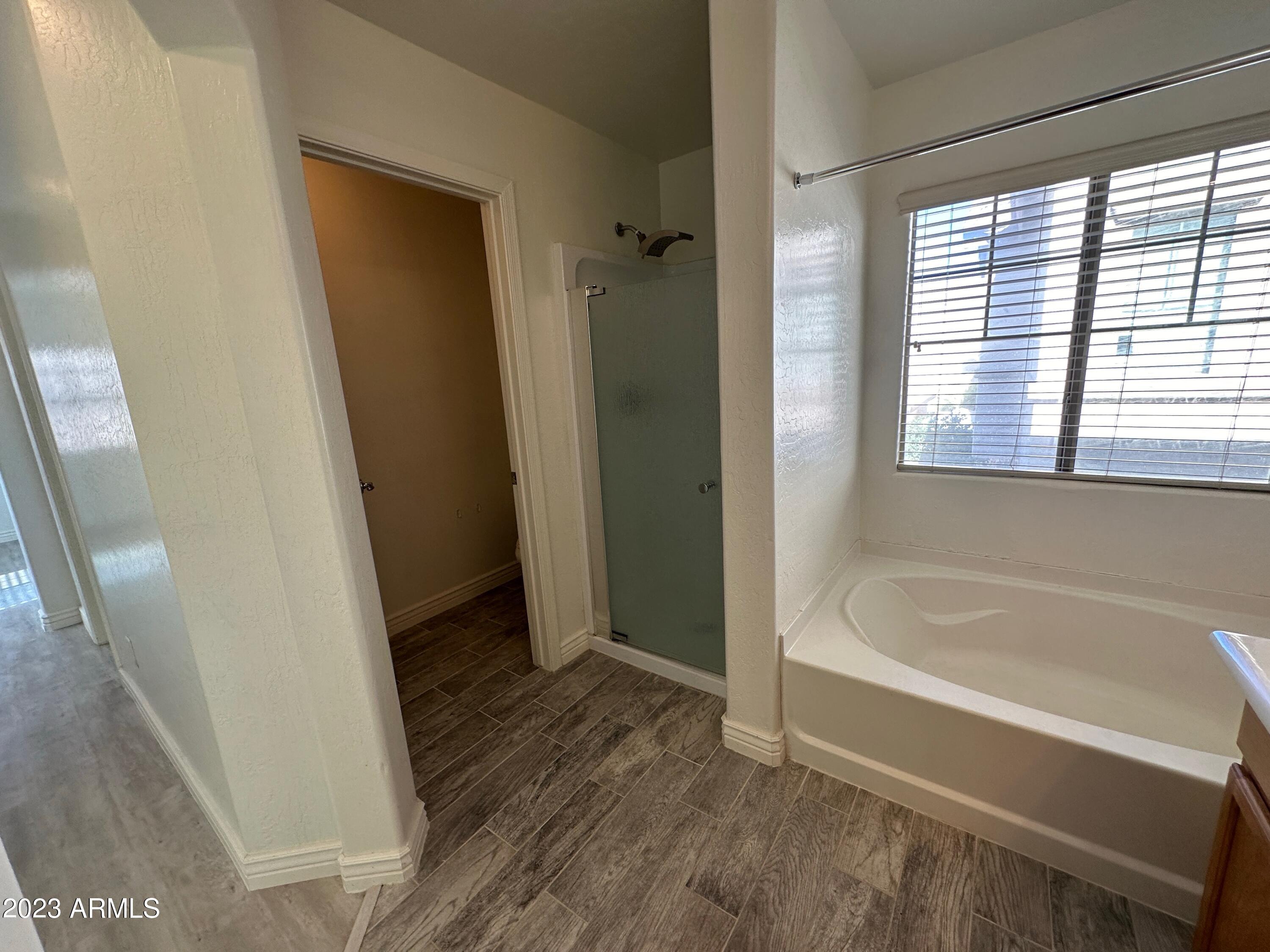 4734 East Olney Avenue Gilbert, AZ 85234 - Photo 26 of 26 a bathroom with a bathtub a toilet and a shower
