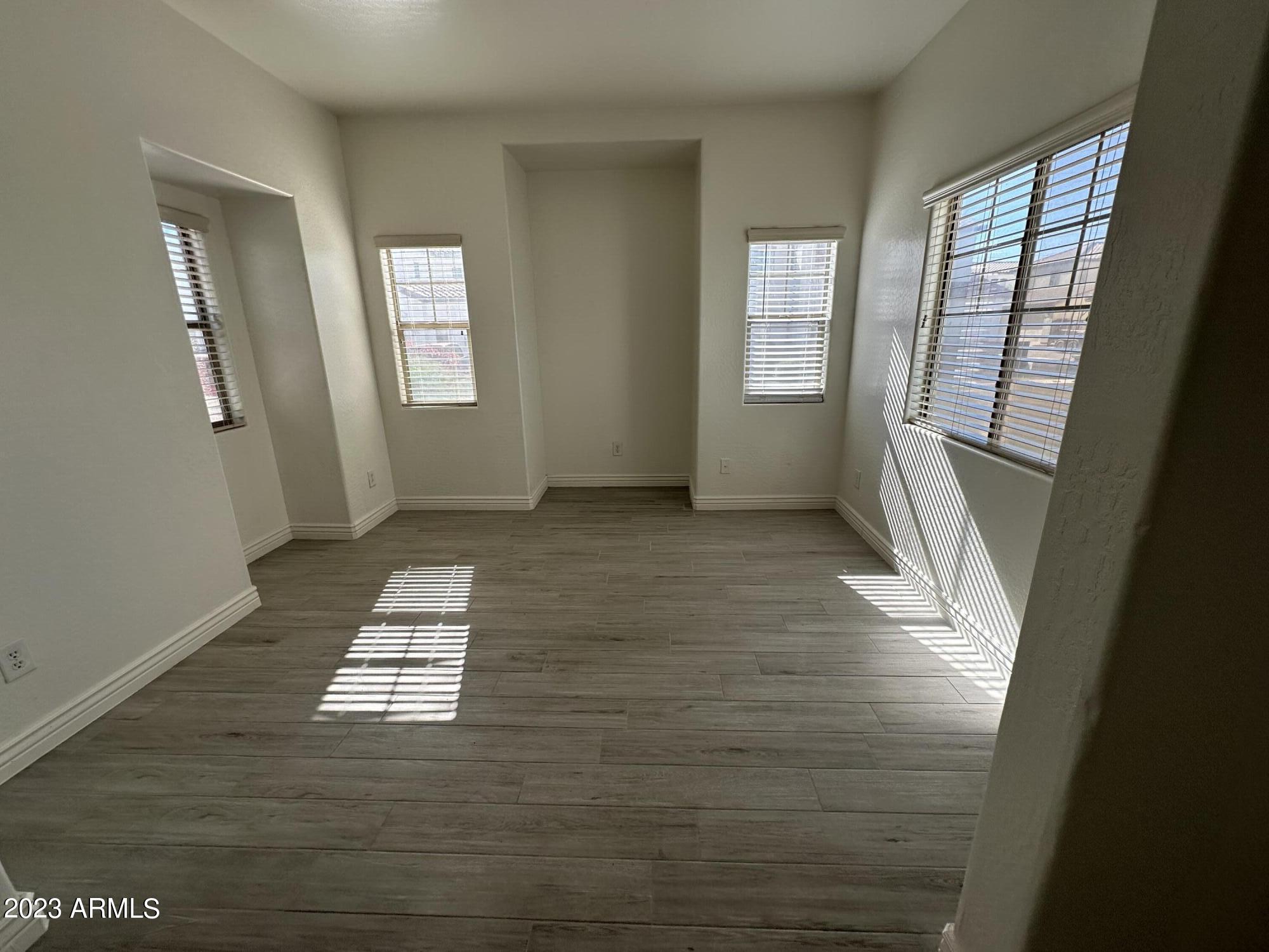 4734 East Olney Avenue Gilbert, AZ 85234 - Photo 3 of 26 a view of livingroom with hardwood floor and window