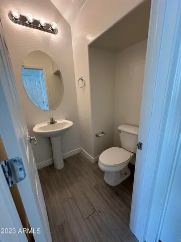 a bathroom with a toilet a sink and mirror
