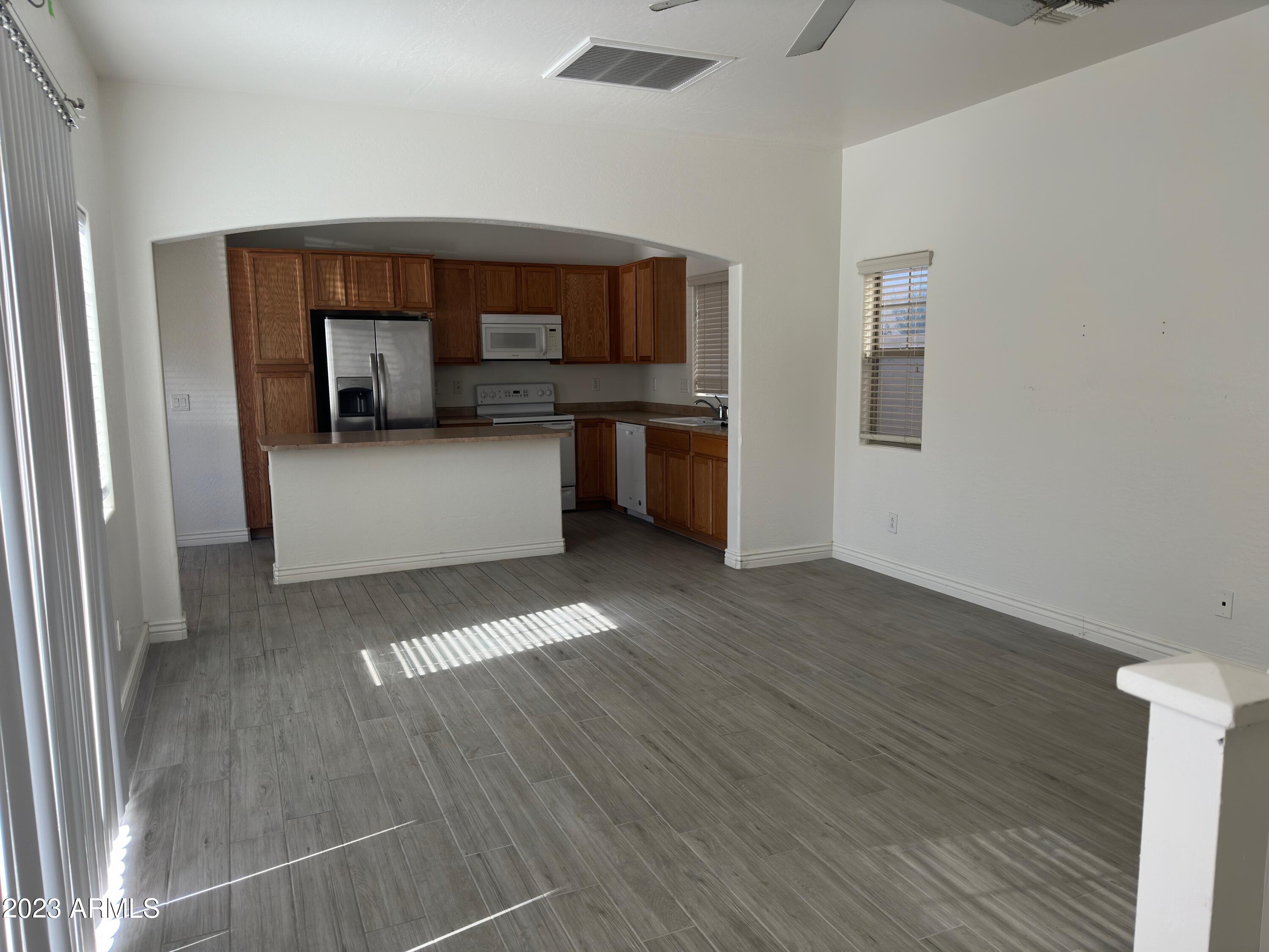 4734 East Olney Avenue Gilbert, AZ 85234 - Photo 7 of 26 a view of a kitchen with a sink cabinets and a window