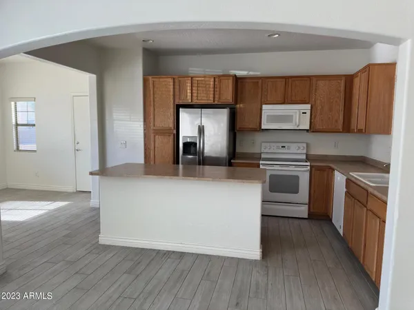 a kitchen with stainless steel appliances a stove top oven a sink and a refrigerator