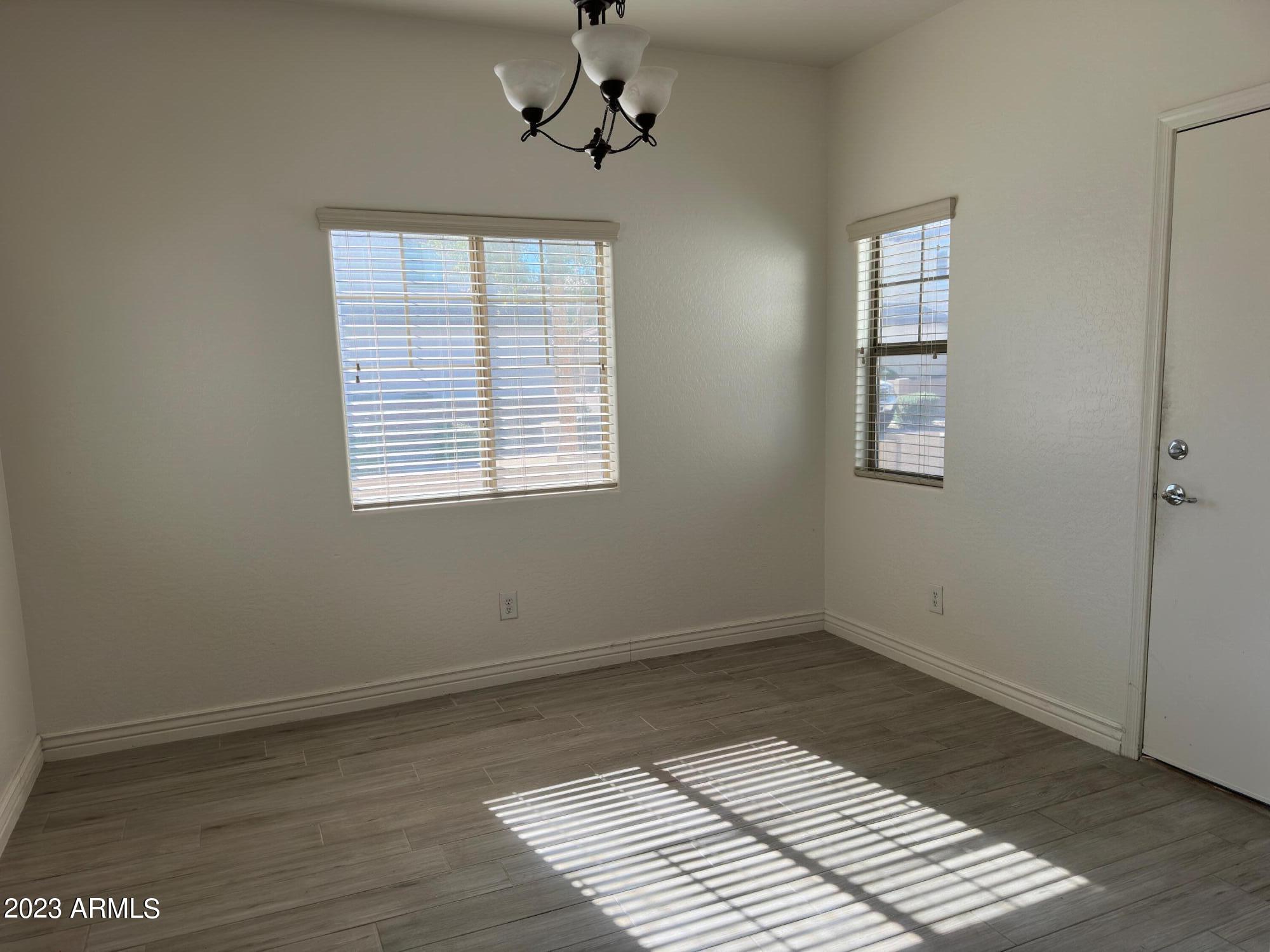 4734 East Olney Avenue Gilbert, AZ 85234 - Photo 10 of 26 a view of a room with wooden floor and windows
