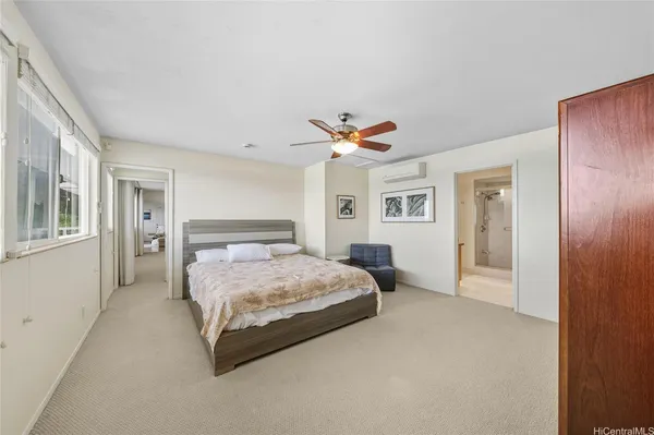a bedroom with a large bed and a chandelier