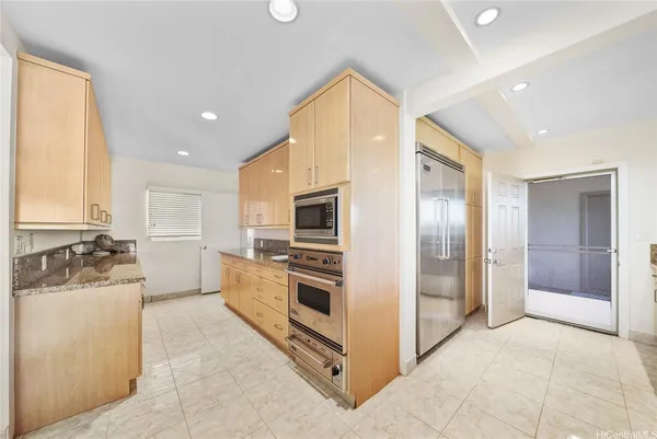a kitchen with a refrigerator and a sink