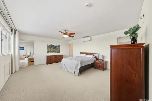 a spacious bedroom with a bed and a table