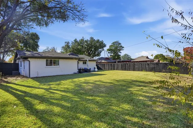 a view of a backyard with a large tree