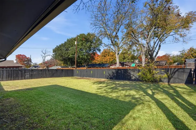 a view of a swimming pool with a patio and a yard