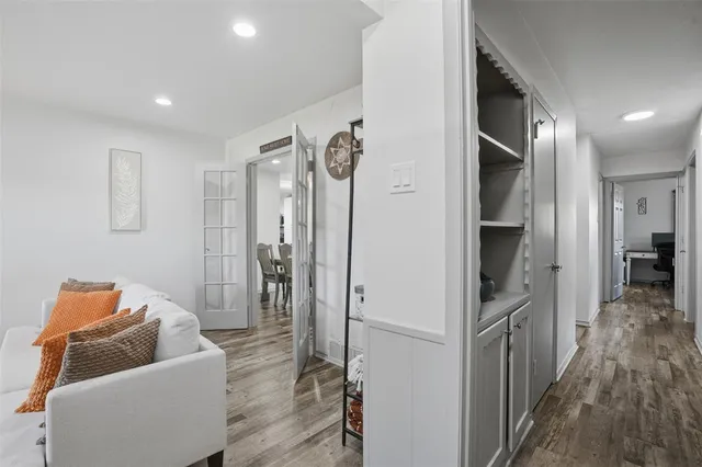 a hallway with furniture and wooden floor