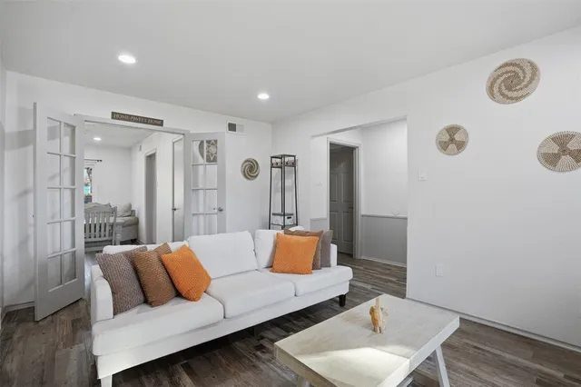a living room with furniture and wooden floor